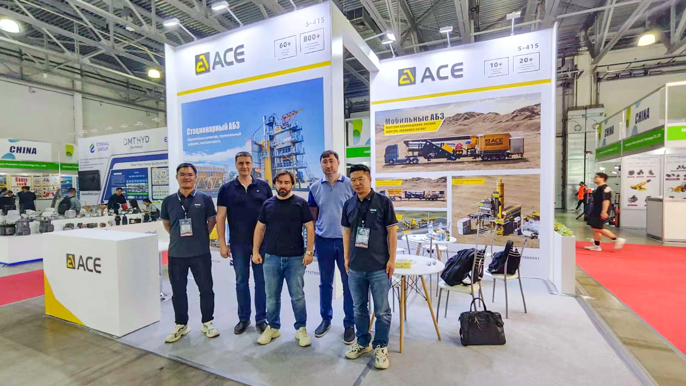 ACE Group experts and customers at a previous exhibition booth, showcasing professional road construction equipment and road-building solutions.