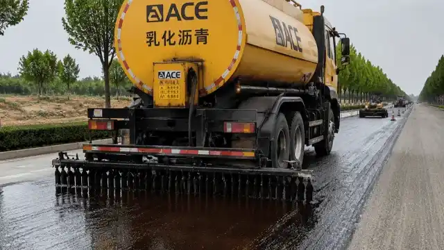 ACE Group emulsified asphalt equipment in action, efficiently spraying and paving roads for industrial construction.